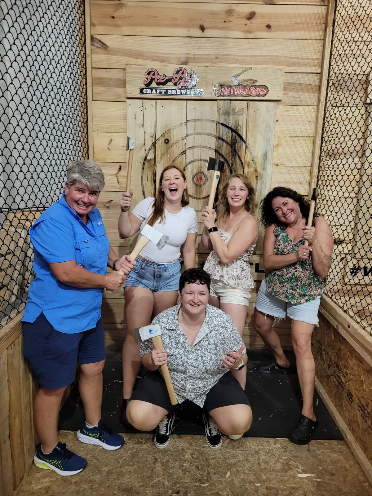 Group enjoying axe throwing